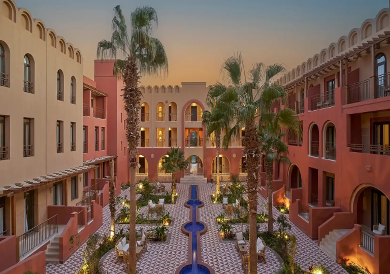 Spa & Trips from Three Corners Ocean View resort courtyard and palm trees in El Gouna